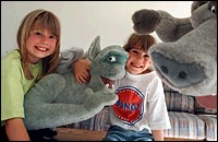 Amber, 9, (left), and Morgan, 6, mugging with stuffed gargoyles their mother, Joanne Roehling, won in a contest.